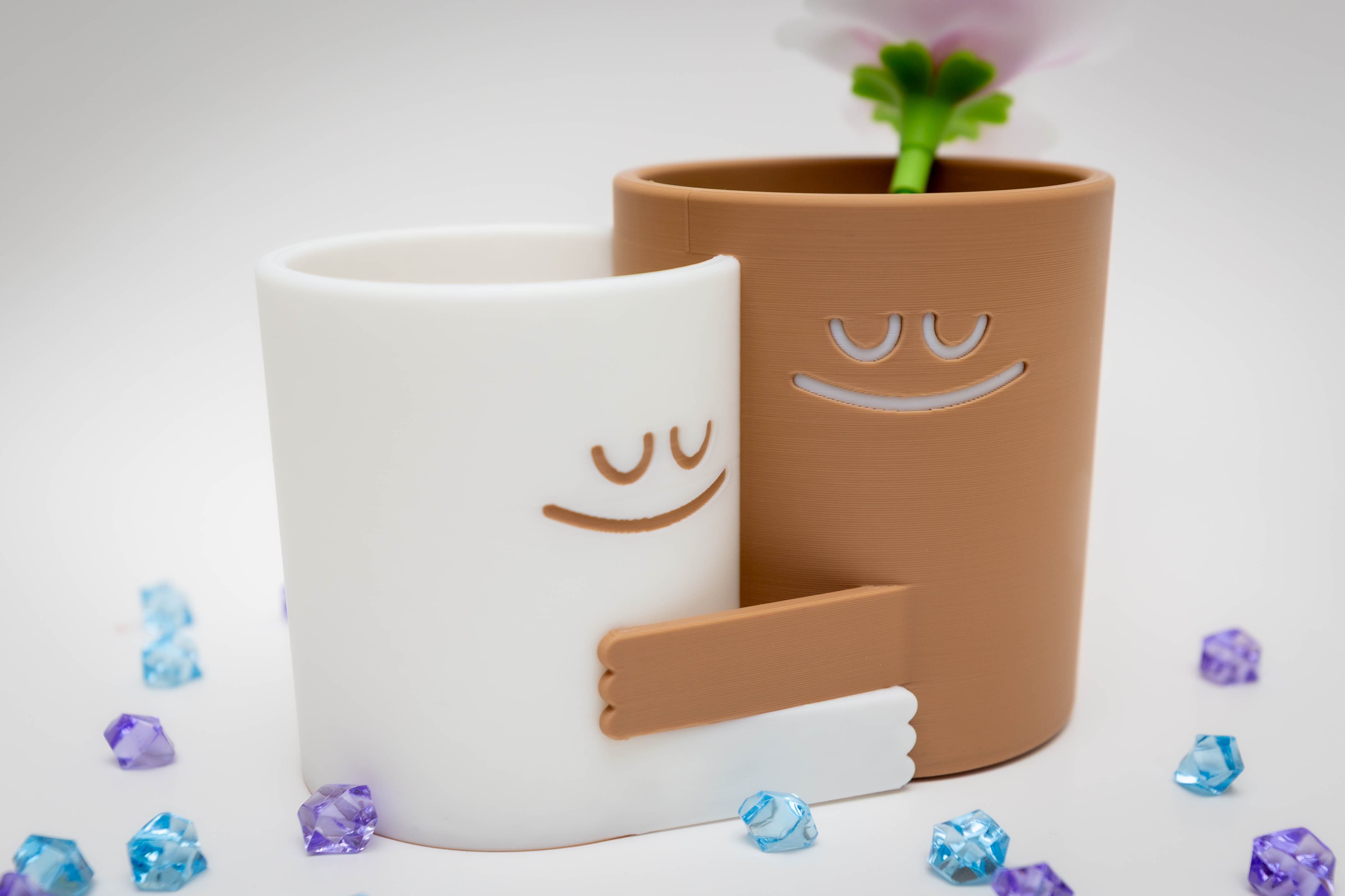 Two smiling planters hugging each other